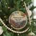 A round ornament on a Christmas tree, featuring a scenic image of Waimea Canyon State Park in Hawaii.