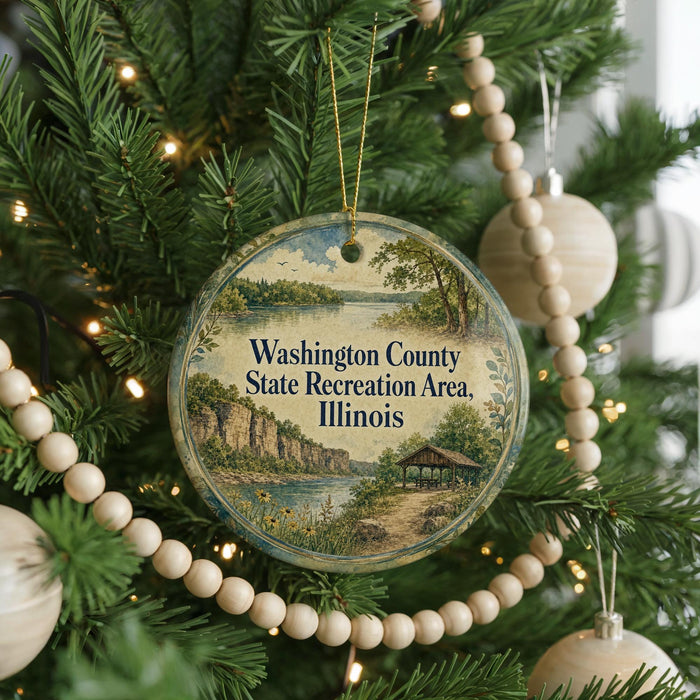 A round ornament hanging on a Christmas tree, featuring a scenic landscape of Washington County, Illinois.