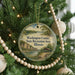 A round ornament hanging on a Christmas tree, featuring a scenic landscape of Washington County, Illinois.