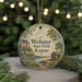 A round ornament with a scenic landscape of Webster State Park, Kansas, featuring a cabin, trees, and a river.