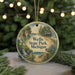 A circular ornament with a scenic illustration of Wells State Park, Michigan, featuring a bird, a waterfall, and a cabin in the background.
