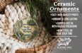 Ceramic ornaments, featuring a painting of Wells State Park, Michigan, hanging in a basket with pine branches.