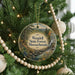 A Christmas tree decorated with ornaments, including a circular ornament with a scenic forest landscape and the text "Wendell State Forest, Massachusetts".
