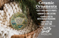 Ceramic ornaments, specifically a round ornament with a bird image, are displayed in a basket with greenery.