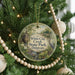 A round ornament hanging on a Christmas tree, featuring a scenic image of White Clay Creek State Park, Delaware.