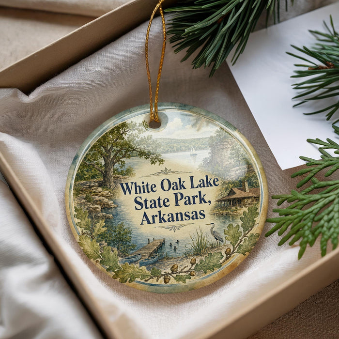 A decorative ornament with a scenic landscape of White Oak Lake State Park, Arkansas, hanging from a string.