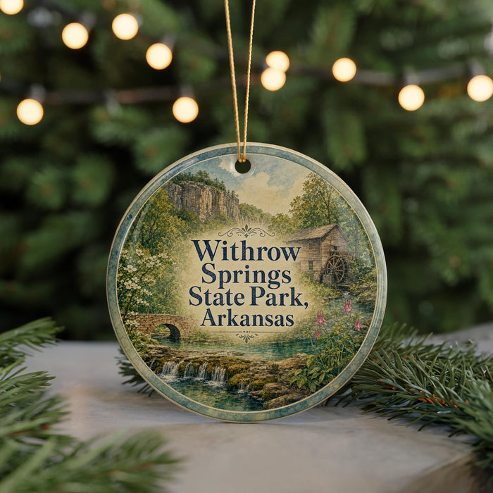 A round ornament with a scenic image of springs, state park, and a bridge, hanging from a string.