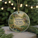 A round ornament with a scenic image of springs, state park, and a bridge, hanging from a string.