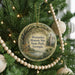A round ornament hanging on a Christmas tree, featuring a scenic image of a historic site in Georgia.