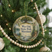 A round ornament hanging on a Christmas tree, featuring a scenic image of Wye Oak State Park, Maryland.