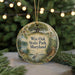 A round ornament with a tree and a bird, featuring the text "Wye Oak State Park, Maryland" on it, is displayed on a table with pine branches and twinkling lights in the background.