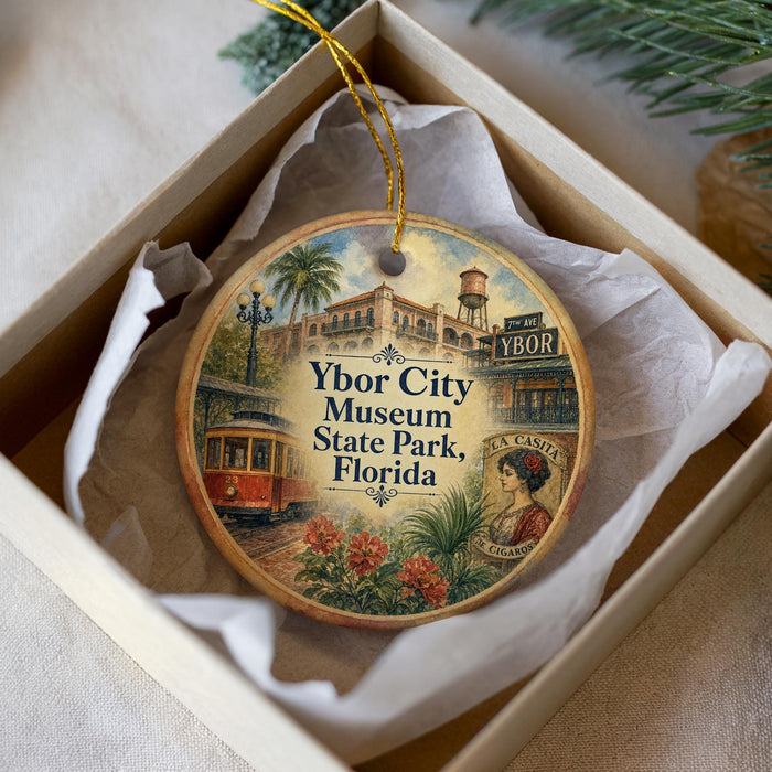 A circular ornament with a vintage-style illustration of a trolley car, palm trees, and a building, along with the text "Ybor City Museum State Park, Florida" and "7th Avenue Ybor".