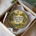 A decorative ornament in a box, featuring a scenic landscape with a deer and the text "Yellow Smoke State Park, Iowa".