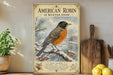 A vintage-style poster of an American robin in winter snow, featuring a detailed illustration of the bird perched on a branch with berries.