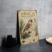 a vintage-style metal sign with an illustration of an American tree sparrow perched on a pine branch, surrounded by pine cones and pine needles.