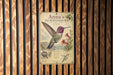 A vintage-style metal sign featuring an illustration of a hummingbird, with text and illustrations related to the bird.