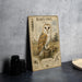 a metal sign with an illustration of a barn owl, placed on a table next to some black camera lenses.