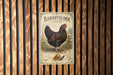 A vintage-style metal sign with an illustration of a chicken, mounted on a wooden wall.
