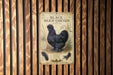 a poster of a black Silkie chicken, which is a breed of chicken known for its distinctive black color and curly feathers.