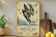 a vintage-style sign with illustrations of pelicans and diving birds, placed on a wooden surface next to a potted plant and a cutting board.