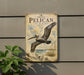 A vintage-style sign featuring a pelican in flight, with the text "BROWN PELICAN IN FLIGHT" prominently displayed.