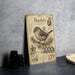 A vintage-style metal sign with illustrations and text about the Bush tit bird, which is a small, gray bird with a distinctive appearance.