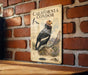 a vintage-style illustration of a California condor, a large bird of prey, perched on a rock against a brick wall.