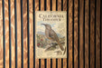 a vintage-style metal sign with illustrations and text, mounted on a wooden wall.