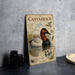 a vintage-style metal sign with a painting of ducks and a bird, placed on a countertop next to some camera equipment.