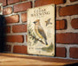 a vintage-style informational sign about the cedar waxwing, a bird species, mounted on a brick wall.