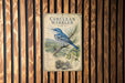 a poster of a blue bird perched on a branch, with a detailed illustration of the bird and its natural surroundings.