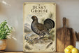A vintage-style poster of a grouse bird, featuring a detailed illustration of the bird in a natural setting, is displayed on a wall next to a wooden cutting board and some kitchen utensils.