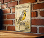 a vintage-style sign for the Eastern Meadow Meadow, with a detailed illustration of a yellow bird perched on a wooden post.