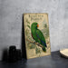 A vintage poster of an Eclectus Parrot, featuring a detailed illustration of the bird perched on a branch with tropical foliage in the background.
