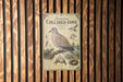 a vintage-style metal sign with illustrations and text, mounted on a wooden wall.