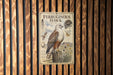 a vintage-style metal sign with illustrations and text about the Ferruginous Hawk, a bird of prey.