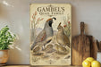 A vintage-style poster of a family of quails, featuring illustrations of the adult and young quails, is displayed on a wall next to a wooden cutting board and some potted plants.