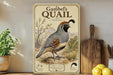 A vintage-style poster of a quail, featuring a detailed illustration of the bird in a desert landscape, is displayed on a shelf next to a wooden cutting board and some potted plants.