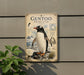 a vintage-style metal plaque depicting a detailed illustration of a Gentoo penguin, with accompanying text providing information about the species.