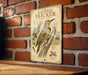 a vintage-style illustration of a gilded flicker, a type of woodpecker, perched on a tree stump against a brick wall background.
