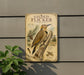 a vintage-style metal sign with a detailed illustration of a gilded flicker, a type of bird, perched on a tree branch.