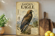 a large poster of a golden eagle, with a detailed illustration of the bird and its natural habitat. The poster is displayed on a wall, and there are some kitchen utensils, such as a knife and a cutting board, visible in the background.
