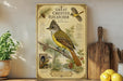 a framed illustration of a Great Crested Flycatcher, a bird with a distinctive yellow and brown plumage, perched on a branch. The illustration includes detailed information about the bird, such as its size, coloration, and habitat. The bird is surrounded by various natural elements, including pine cones and berries, creating a serene and picturesque scene. The image is set against a backdrop of a wooden shelf, with a potted plant and a wooden cutting board visible in the foreground.