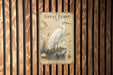a poster of a great egret, a large wading bird, standing in a pond surrounded by plants and a water lily.