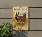 a vintage-style sign with a prairie chicken illustration, mounted on a wall next to a plant.