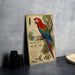 A vintage-style metal sign featuring a colorful parrot, with text and illustrations, is displayed on a gray countertop next to a stack of black camera lenses.