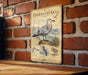 a metal sign with illustrations and text about seagulls, mounted on a brick wall.