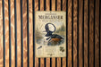 a sign for the Hooded Merganser, a type of duck, mounted on a wooden wall.