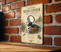 a sign with a duck illustration and text, mounted on a brick wall.