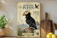 a poster of a horned puffin, a seabird, on a shelf next to a wooden cutting board and some fruit.